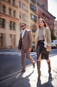 a man and woman walking down the street