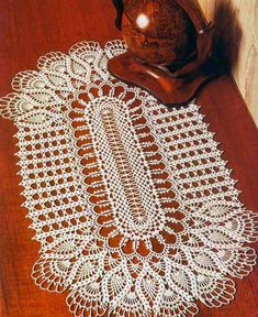 a wooden table topped with a white doily