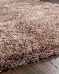 a brown rug on top of a wooden floor