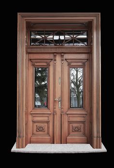 the front door is made of wood and has two sidelights on each side,