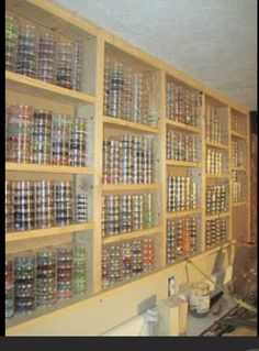 a room filled with lots of bottles and shelves full of empty beer cans on the wall