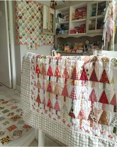 a quilt is hanging on a clothes line in a room