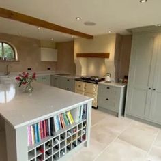 a large kitchen with an island in the middle and lots of cabinets on both sides