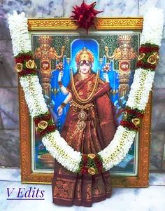 an image of the hindu god in front of a frame decorated with flowers and garlands