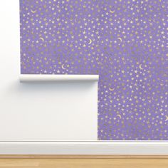 a purple wall with gold stars and crescents on it