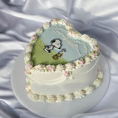 a white cake with a cartoon sheep on it