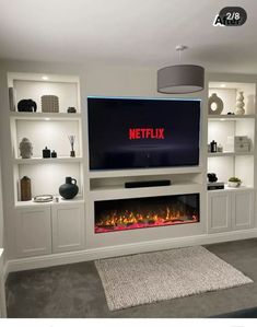 a living room with a fireplace and entertainment center