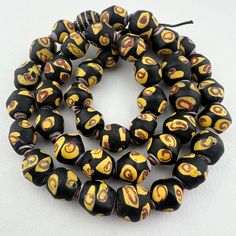 the beads are black and yellow with smiley faces on them