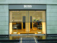 the entrance to boss's new york store is lit up with yellow and black lights