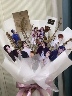 a bouquet with photos and ribbons tied to it