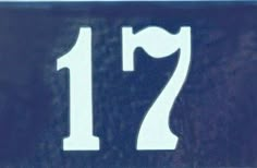 a blue and white street sign with the number 17 on it