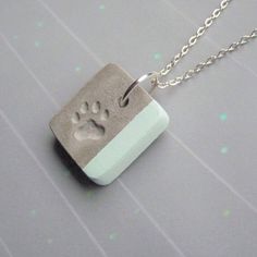 a necklace with a dog's paw on it