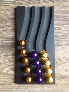 a wooden table topped with black and gold items