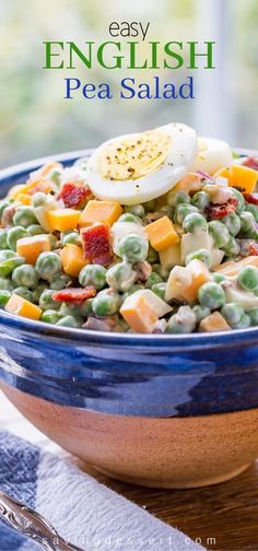 a blue bowl filled with peas and an egg