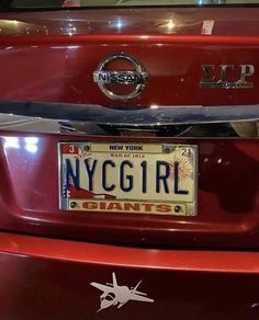 a red car with a license plate that says nyc girl giants on it's front