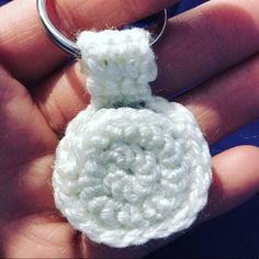 a crocheted keychain is being held in the palm of someone's hand