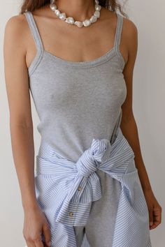 The Baby Rib Scallop Tank is crafted with our softest fabric yet, featuring a slightly cropped fit and scalloped edges on the neckline & straps. Set it up with — The Baby Rib Scallop Pant Made in LA Summer Gray Cotton Camisole, Gray Summer Tops For Daywear, Fitted Tops With Tie Straps For Daywear, Chic Gray Cotton Tank Top, Scallop Pants, Vintage Designer Bags, Danielle Guizio, Set It Up, Perfect White Tee