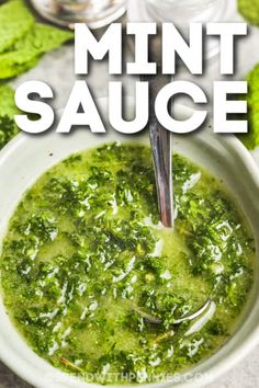 a white bowl filled with green sauce on top of a table