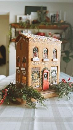 a gingerbread house is sitting on a table