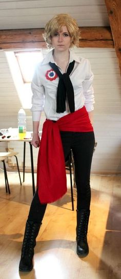 a woman dressed in black and white is posing for the camera while wearing a red skirt