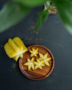 some cut up pieces of fruit on a wooden plate