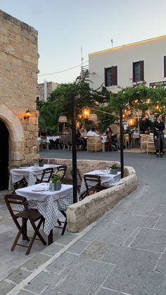 an outdoor dining area with tables and chairs