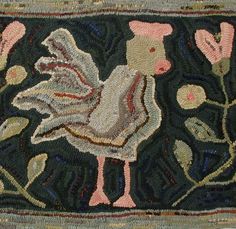 an old rug with a bird and flowers on the side, in front of a black background