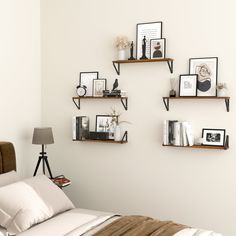 the wall is filled with books, pictures and other things to decorate in this room