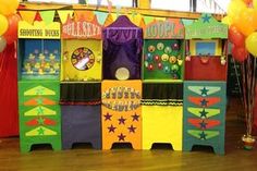 a carnival booth with balloons on the floor