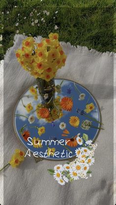 yellow flowers in a vase on a blue plate with the words summer aesthetic above it