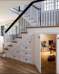 an open door leading to a white staircase in a home with hardwood floors and stairs