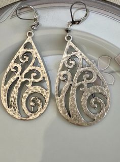 Beautifully unique hammered antique silver earrings. A pretty design with a silver bead that finishes the earrings. The earring is 54x30mm and dangles 2" on Sterling Plated Lever backs Beautiful earrings that are great for work or casual very eye catching UniquelybyRuth pays for your first class shipping when your order is $35 or more, so take a look around the shop and see if anything else calls to you! 🆓 Silver Teardrop Metal Clip-on Earrings, Silver Hammered Bohemian Earrings, Silver Teardrop Bohemian Clip-on Earrings, Bohemian Silver Hammered Earrings, Bohemian Silver Teardrop Clip-on Earrings, Silver Hammered Dangle Chandelier Earrings, Silver Hammered Chandelier Drop Earrings, Silver Hammered Metal Chandelier Earrings, Silver Hammered Chandelier Earrings As Gift