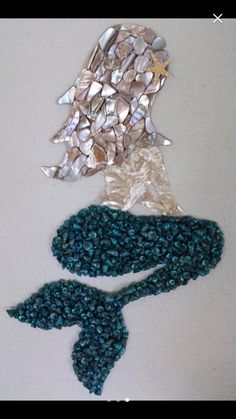 two pieces of beaded fabric with shells and starfishs on them, one in the shape of a mermaid's tail