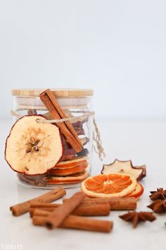 an apple, cinnamon and star anise in a jar