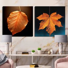 two paintings of leaves on a wall in a living room