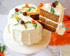 a slice being taken out of a carrot cake