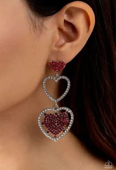 A red rhinestone-encrusted silver heart, white rhinestone-encrusted silver heart frame, and white and red rhinestone-encrusted layered heart frame gradually increase in size as they delicately interconnect and stack into a dazzling lure for an elegant effervescence. Earrings attaches to a standard post fitting. Sold as one pair of post earrings. Heart Frame, Red Earrings, White And Red, Silver Heart, Post Earrings, Frame, Silver, Red, White