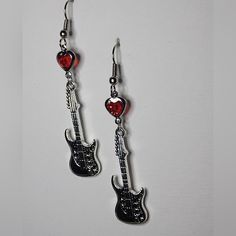 These Unique Guitar Earrings Are A Must-Have For Any Music Lover. The Dangle/Drop Style With A Hook Closure Is Perfect For Everyday Wear And The Red Heart-Shaped Stone Adds A Pop Of Color To Any Outfit. The Earrings Are Designed For The Lobe Area And Are Perfect For Anyone Who Loves The Sound Of Music. The Earrings Are Categorized Under Jewelry & Watches And Fashion Jewelry, Specifically Earrings. The Blue Color And Guitar Theme Make Them A Great Addition To Any Jewelry Collection. These Earring Guitar Earrings, Music Earrings, The Sound Of Music, Unique Guitars, Sound Of Music, Music Lover, The Sound, Red Heart, Heart Charm