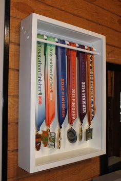 an assortment of medals are displayed in a shadow box