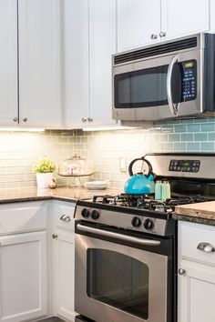 a stove top oven sitting inside of a kitchen next to a microwave above a counter