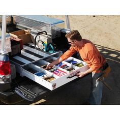 a man loading items into the back of a truck