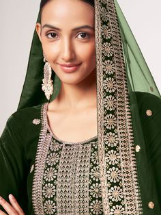 Elevate your style with this magnificent green velvet suit, adorned with intricate sequin work, zari work, and exquisite embroidery. The lush velvet fabric exudes opulence, while the meticulous craftsmanship adds a touch of glamour to the ensemble. This green suit is a perfect blend of traditional elegance and contemporary flair, ideal for making a statement at festivals, functions, and special events.
Accompanying the suit are matching santoon pants, featuring delicate embroidery and shimmering Velvet Kameez, Engagement Gown, Suit With Dupatta, Lehenga Crop Top, Lehenga Choli Wedding, Floral Lehenga, Party Wear Lehenga Choli, Reception Gown, Cocktail Wear