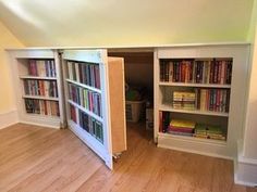 an open bookcase in the corner of a room with hard wood floors and white walls