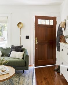 a living room filled with furniture and a wooden door