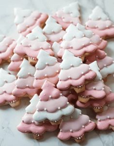 pink and white decorated cookies on a table