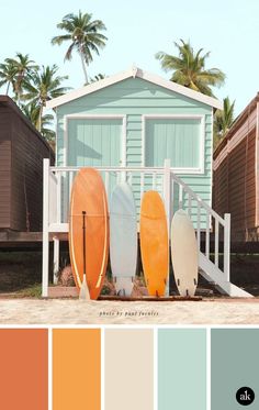 surfboards are lined up in front of a beach house