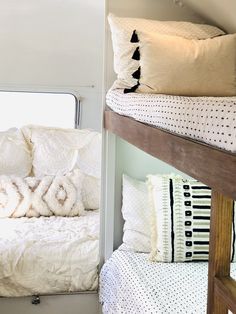 bunk beds in a small room with pillows on them