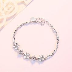 Product Information： Material: Silver Finishing: diamond set Type: bracelet Style: Women's Shape: Leaf Colour: S04 Popular elements: flowers Size: 3cm extension chain Package contents： Bracelet X1 Dainty Flower-shaped Crystal Bracelet, Elegant Crystal Bracelet With Flower Charm, Dainty Silver Flower Charm Bracelet, Dainty Flower-shaped Metal Bracelets, Silver Flower Crystal Bracelet As Gift, Silver Flower Crystal Bracelet Gift, Silver Flower Crystal Bracelet For Gift, European Women, Bracelet Style