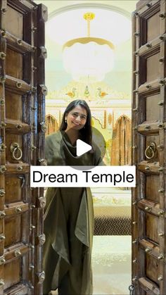 a woman standing in front of an open door with the words dream temple on it