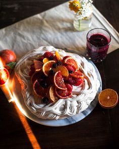 a white plate topped with sliced oranges and blood orange slices